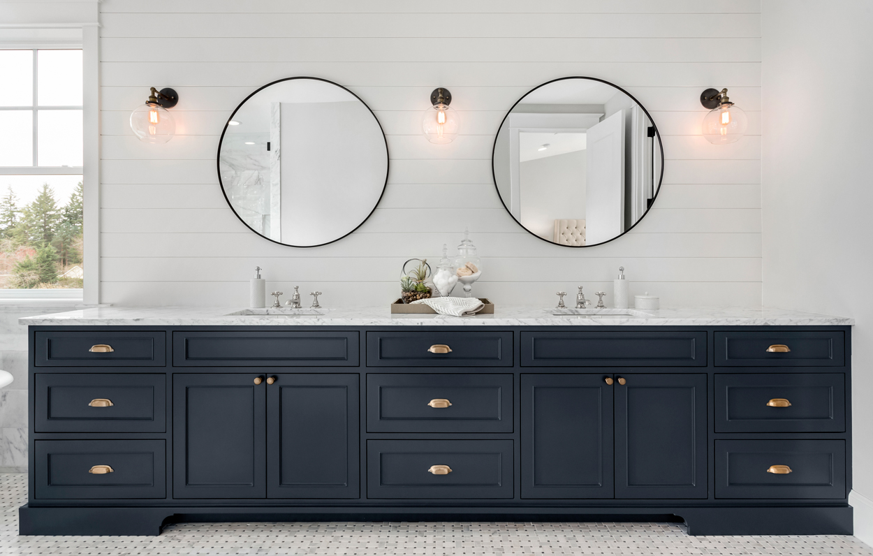 bathroom cabinets with two mirrors.