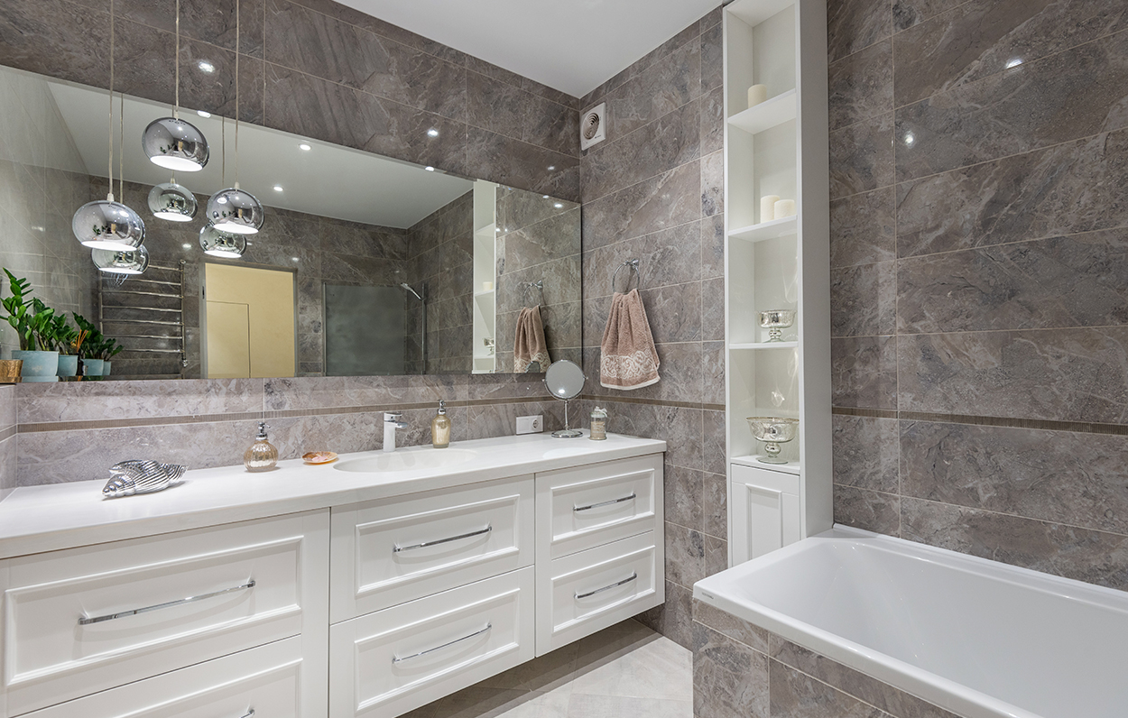 bathroom with marble walls and cabinets,
