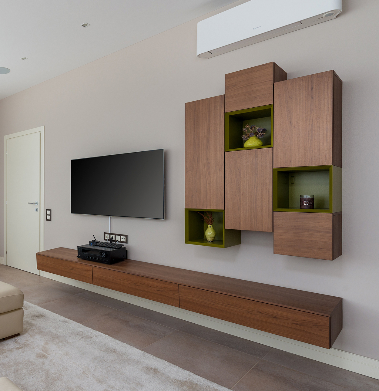 tv hung on wall with cabinets.