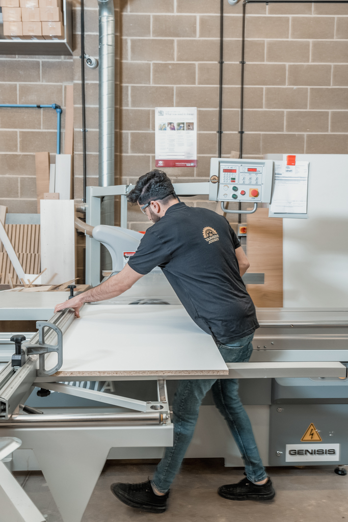 yasmeen joinery employee cutting wood.
